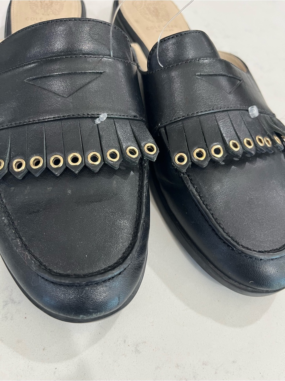 Cole Haan Black Leather Fringe Penny Loafers with Gold Eyelets
